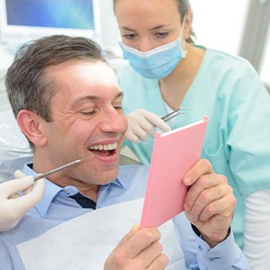 Patient in Rocky River smiling with completed dental implant restoration