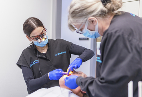 Dentist and assistant performing a procedure on a dental patient