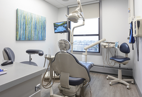 Dental exam room with white walls and a window