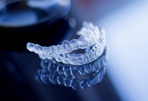 Set of clear aligners against dark background