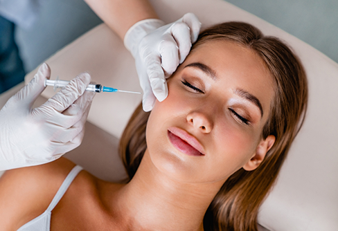 Woman receiving a Botox injection in her cheek