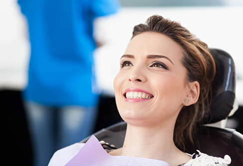 Brunette woman smiling in dental chair