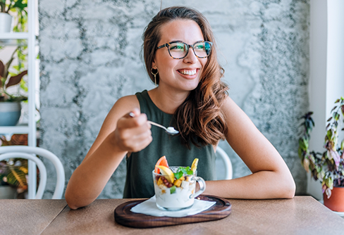 Young woman eating yogurt parfait