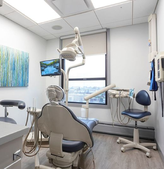 Dental exam room with white walls and a window