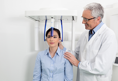 Dental patient receiving a C T cone beam scan of her mouth and jaws