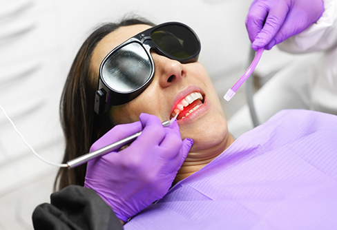 Dental patient receiving gum treatment with a soft tissue laser