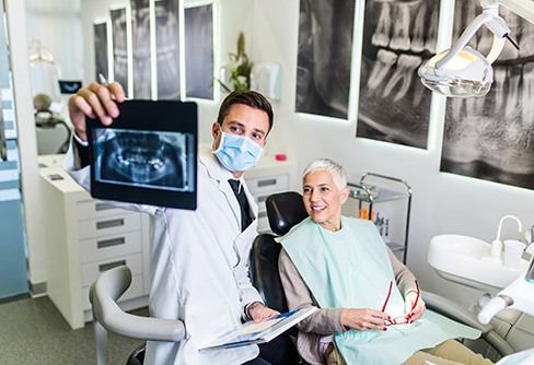 Dentist and patient reviewing X-ray together