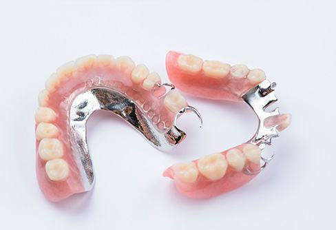 Two partial dentures pictured against white background