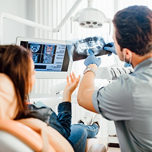 Dentist reviewing X-ray with patient