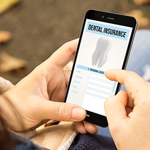Patient looking at dental insurance form on phone
