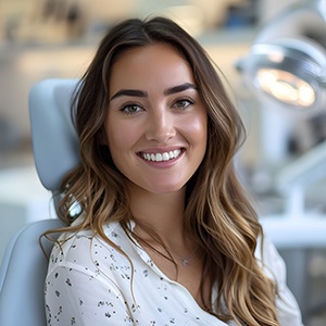 Woman smiling while sitting in treatment chair