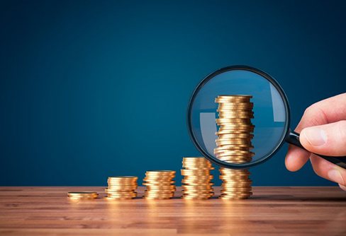 Coins examined with magnifying glass