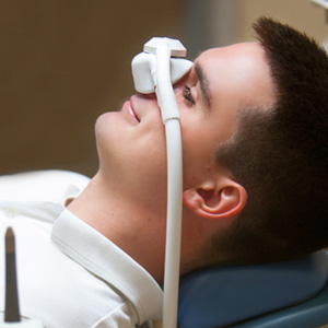 Patient relaxing while breathing in nitrous oxide in treatment chair