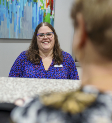 Dental office receptionist smiling at a patient
