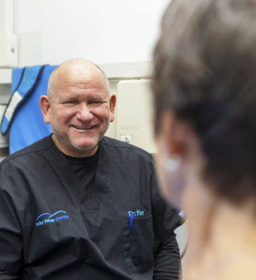 Dentist grinning at a patient