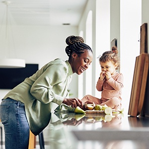 Mom and daughter eating snack in kitchen