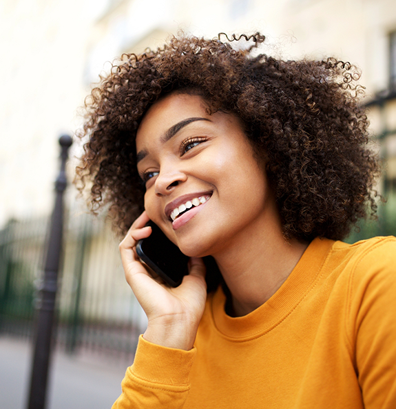 Woman talking on the phone to request a dental appointment