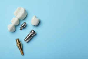 Parts of a dental implant lying on a blue background